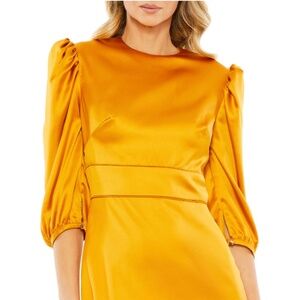 Sleek golden satin dress with puffed three-quarter sleeves